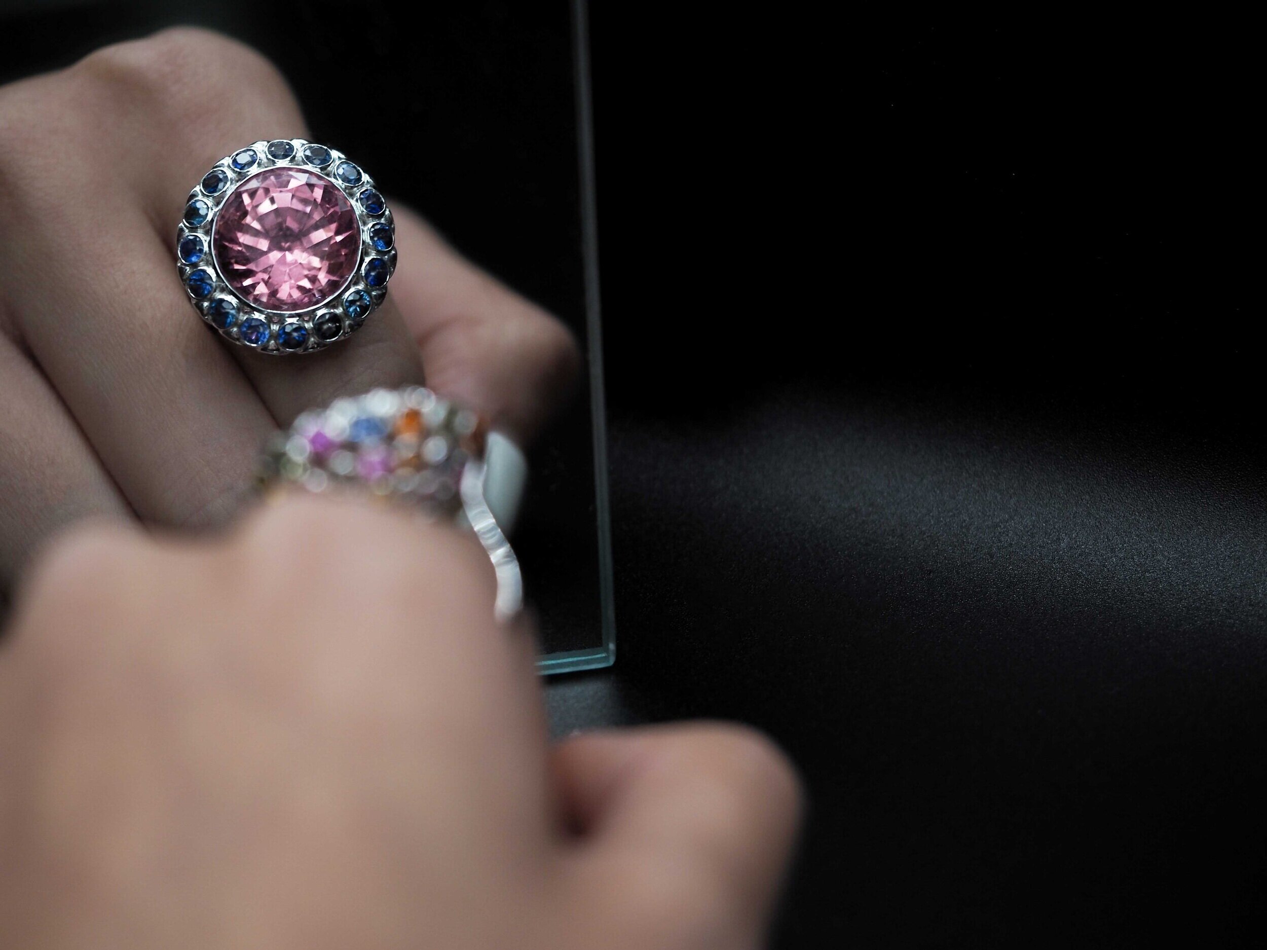 Close-up of coloured gemstone jewelry worn on the hand